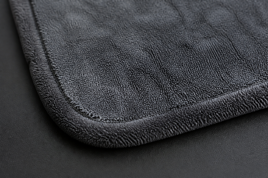 Close-up of charcoal microfiber pile and stitched edge